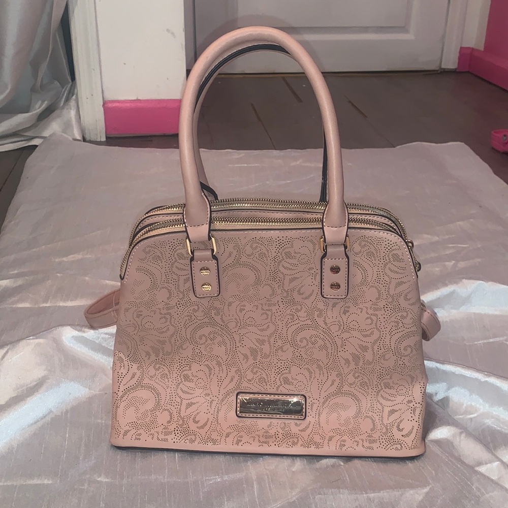 Light pink Marc New York Andrew Marc purse. Has long crossbody strap.